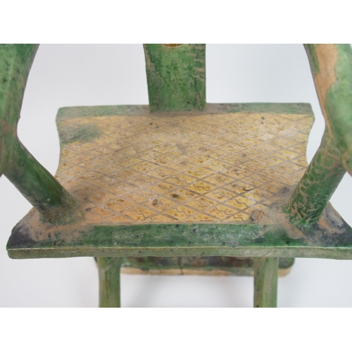 113 - A Tang style horseshoe back armchair