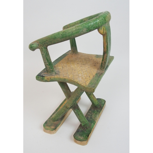 113 - A Tang style horseshoe back armchair