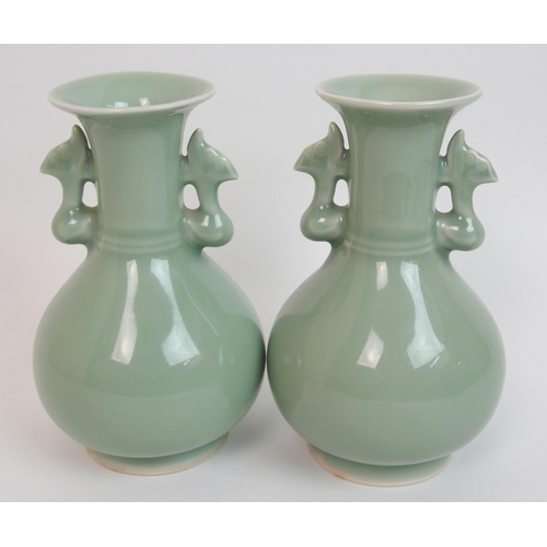 119 - A pair of Chinese celadon ground two-handled baluster vases