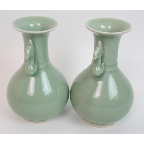 119 - A pair of Chinese celadon ground two-handled baluster vases