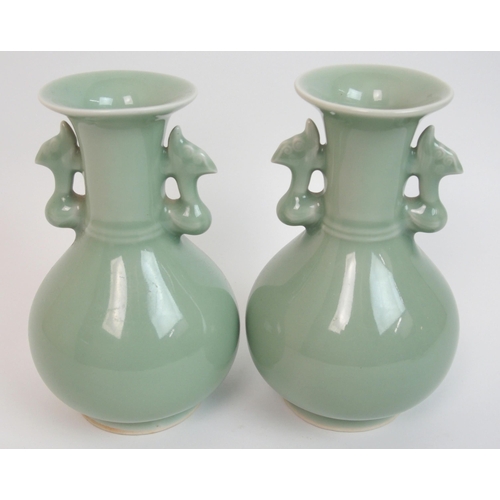 119 - A pair of Chinese celadon ground two-handled baluster vases