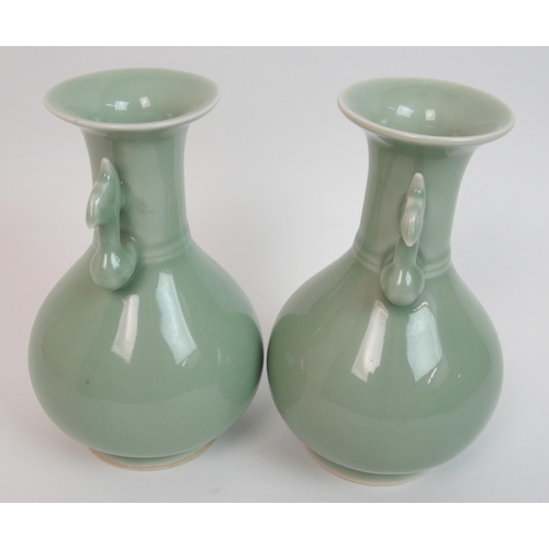 119 - A pair of Chinese celadon ground two-handled baluster vases