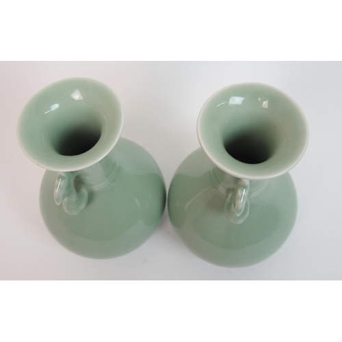 119 - A pair of Chinese celadon ground two-handled baluster vases