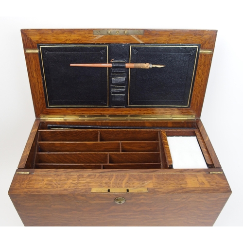 301 - A Victorian stained oak stationery box and writing slope