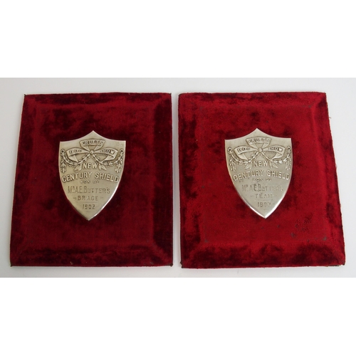 323 - Two white-metal Cruft's Dog Show shield-shaped plaques