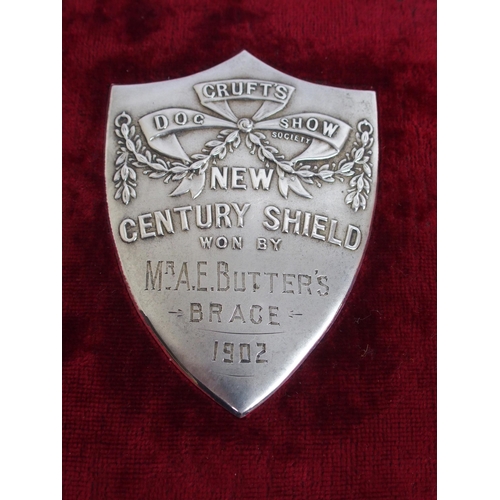 323 - Two white-metal Cruft's Dog Show shield-shaped plaques