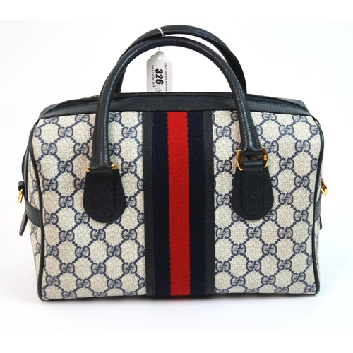 326 - A Gucci handbag with leather carrying handles