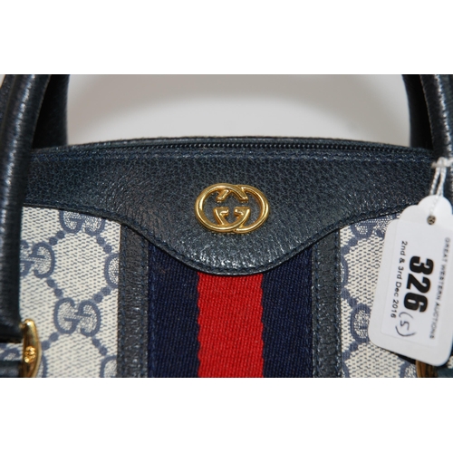 326 - A Gucci handbag with leather carrying handles