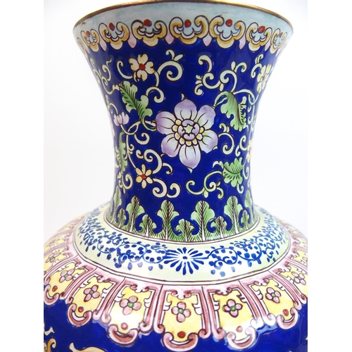 69 - A Persian enamel and copper baluster vase