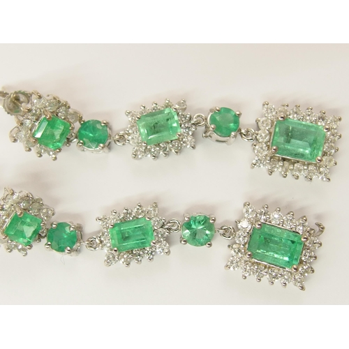 778 - A pair of long dangly diamond and emerald earrings