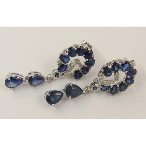 779 - A pair of 14ct white gold diamond and sapphire earrings