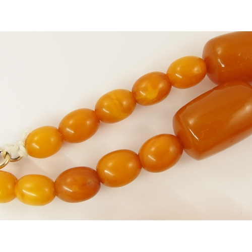 788 - A string of amber coloured beads