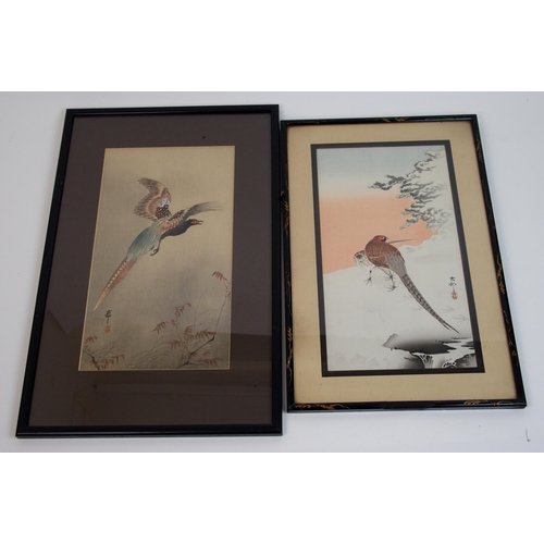 79 - A Japanese woodblock print of a lady and child beneath blossom