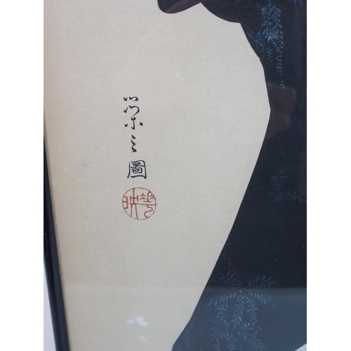 79 - A Japanese woodblock print of a lady and child beneath blossom