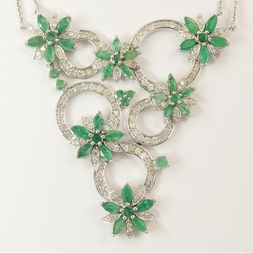 794A - A 14ct white gold substantial emerald and diamond flower necklace