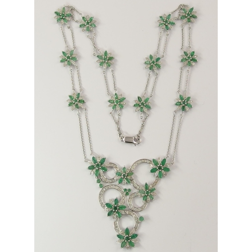 794A - A 14ct white gold substantial emerald and diamond flower necklace