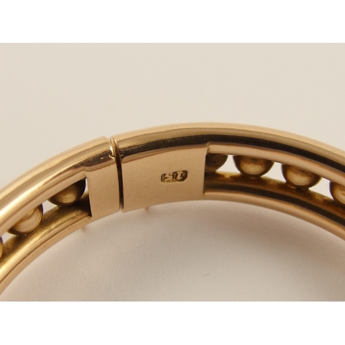 797B - A 15ct rose gold Early 20th century bangle