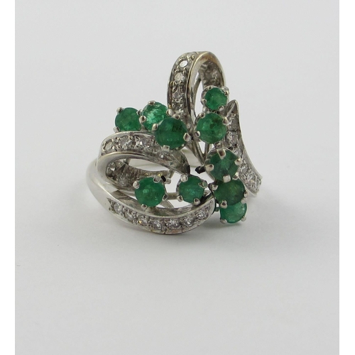 798 - An emerald and diamond cluster ring