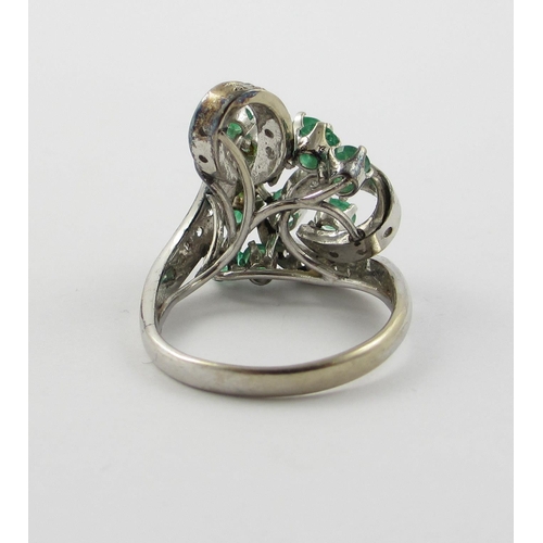 798 - An emerald and diamond cluster ring