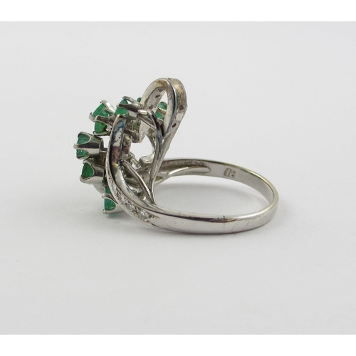 798 - An emerald and diamond cluster ring