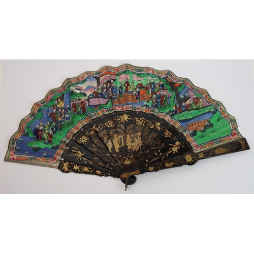 91 - A Chinese export black and gold double-sided lacquered fan