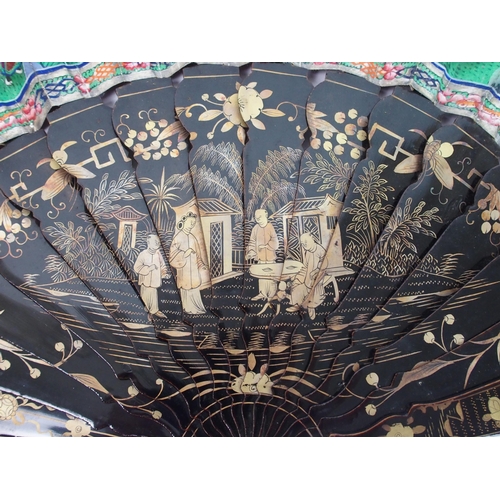 91 - A Chinese export black and gold double-sided lacquered fan