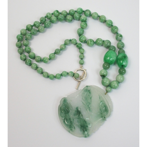 97 - A Chinese green hardstone pendant necklace