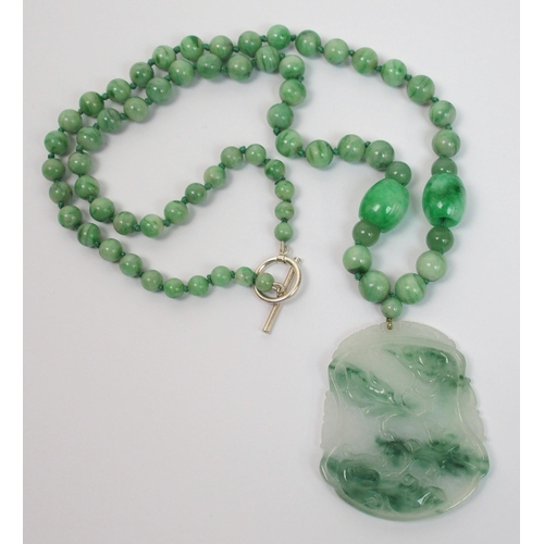 97 - A Chinese green hardstone pendant necklace