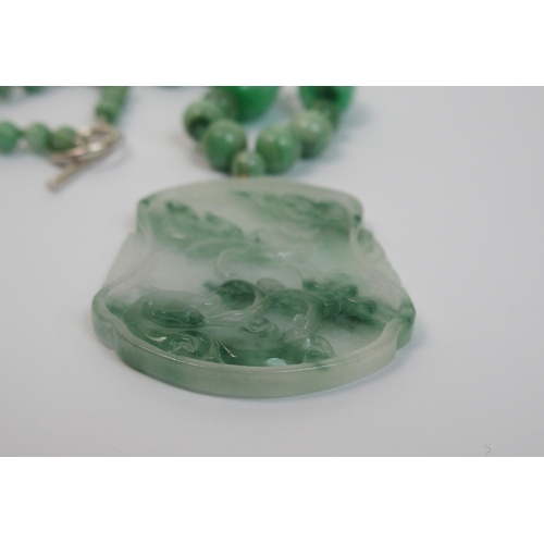 97 - A Chinese green hardstone pendant necklace