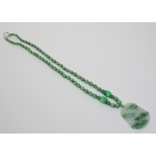 97 - A Chinese green hardstone pendant necklace