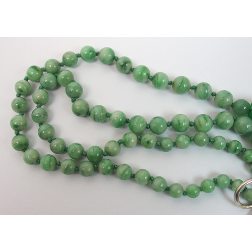 97 - A Chinese green hardstone pendant necklace