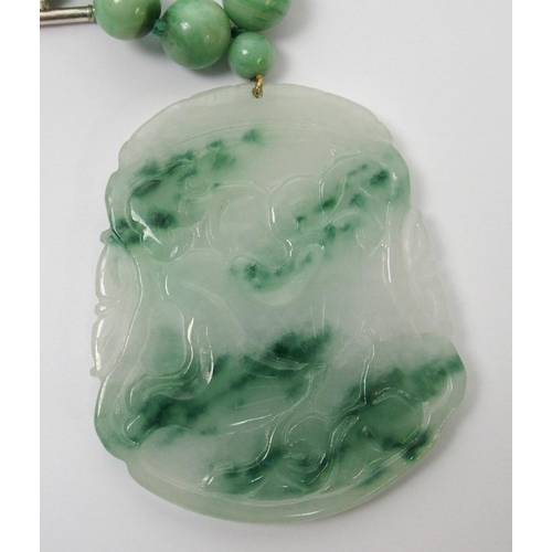 97 - A Chinese green hardstone pendant necklace