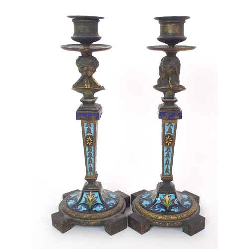 1062 - A pair of French champleve enamel and gilt bronze candlesticks