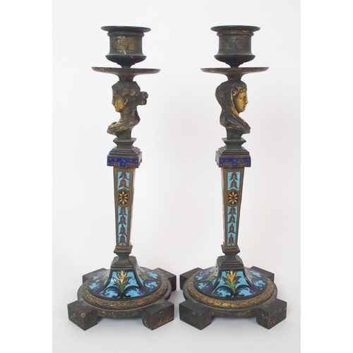 1062 - A pair of French champleve enamel and gilt bronze candlesticks