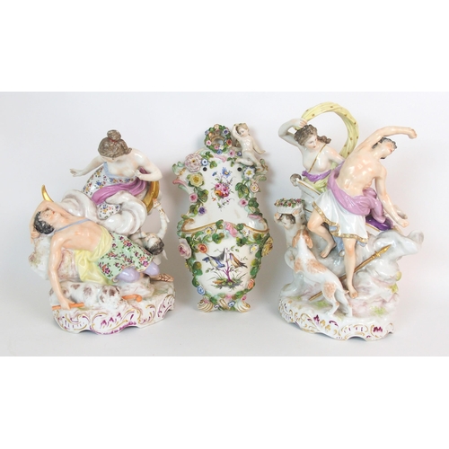 1064 - A pair of Continental porcelain figural groups and a Continental porcelain wall pocket