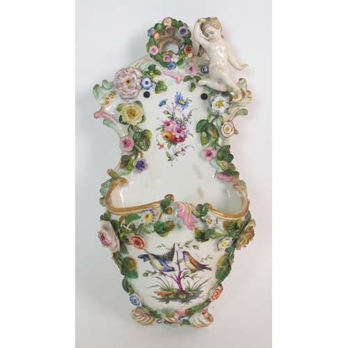 1064 - A pair of Continental porcelain figural groups and a Continental porcelain wall pocket