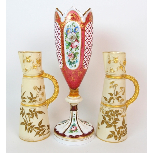 1065 - A pair of Royal Worcester porcelain ewers with a cranberry glass and enamelled footed vase