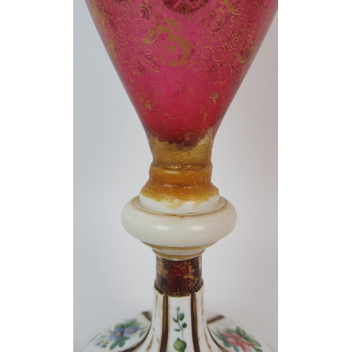 1065 - A pair of Royal Worcester porcelain ewers with a cranberry glass and enamelled footed vase