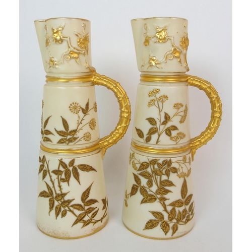 1065 - A pair of Royal Worcester porcelain ewers with a cranberry glass and enamelled footed vase