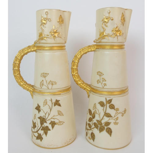 1065 - A pair of Royal Worcester porcelain ewers with a cranberry glass and enamelled footed vase