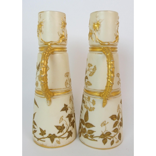 1065 - A pair of Royal Worcester porcelain ewers with a cranberry glass and enamelled footed vase