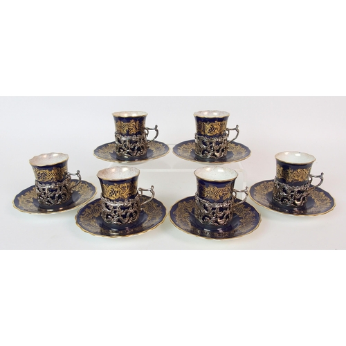 1073 - A Coalport six piece porcelain coffee can and saucer set with silver mounts