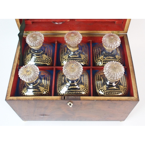 1075 - An English Regency decanter set in mahogany case