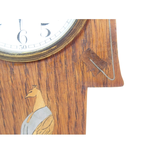 1076 - An Arts and Crafts oak mantle clock