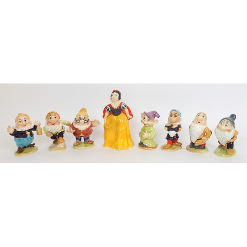 1090 - A Group of Beswick figures depicting Snow White and the Seven Dwarfs