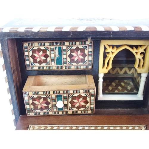 1122 - A Moroccan-style mahogany and fruitwood inlaid miniature cabinet