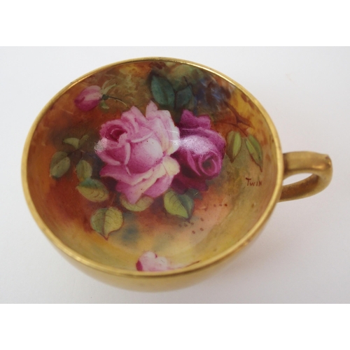 1124 - A Royal Worcester painted porcelain cabinet cup and saucer