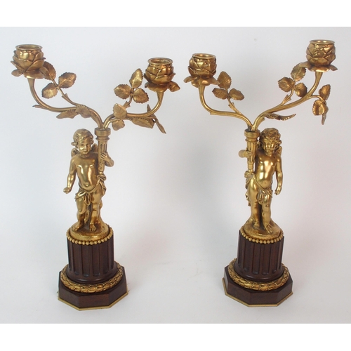 1144 - A French gilt bronze and carved oak three piece clock garniture