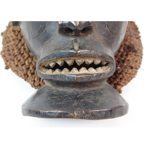 12 - An African carved wood  hair and wicker mask
