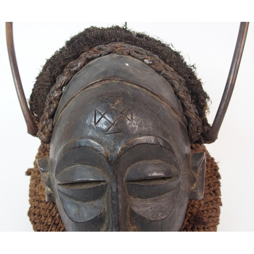 12 - An African carved wood  hair and wicker mask